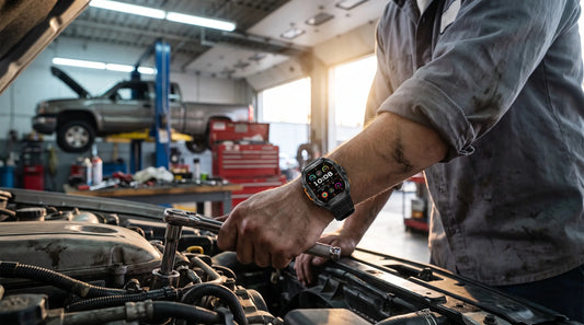 Horonix Raptor X5 rugged smartwatch on a mechanic's wrist while working under a truck hood